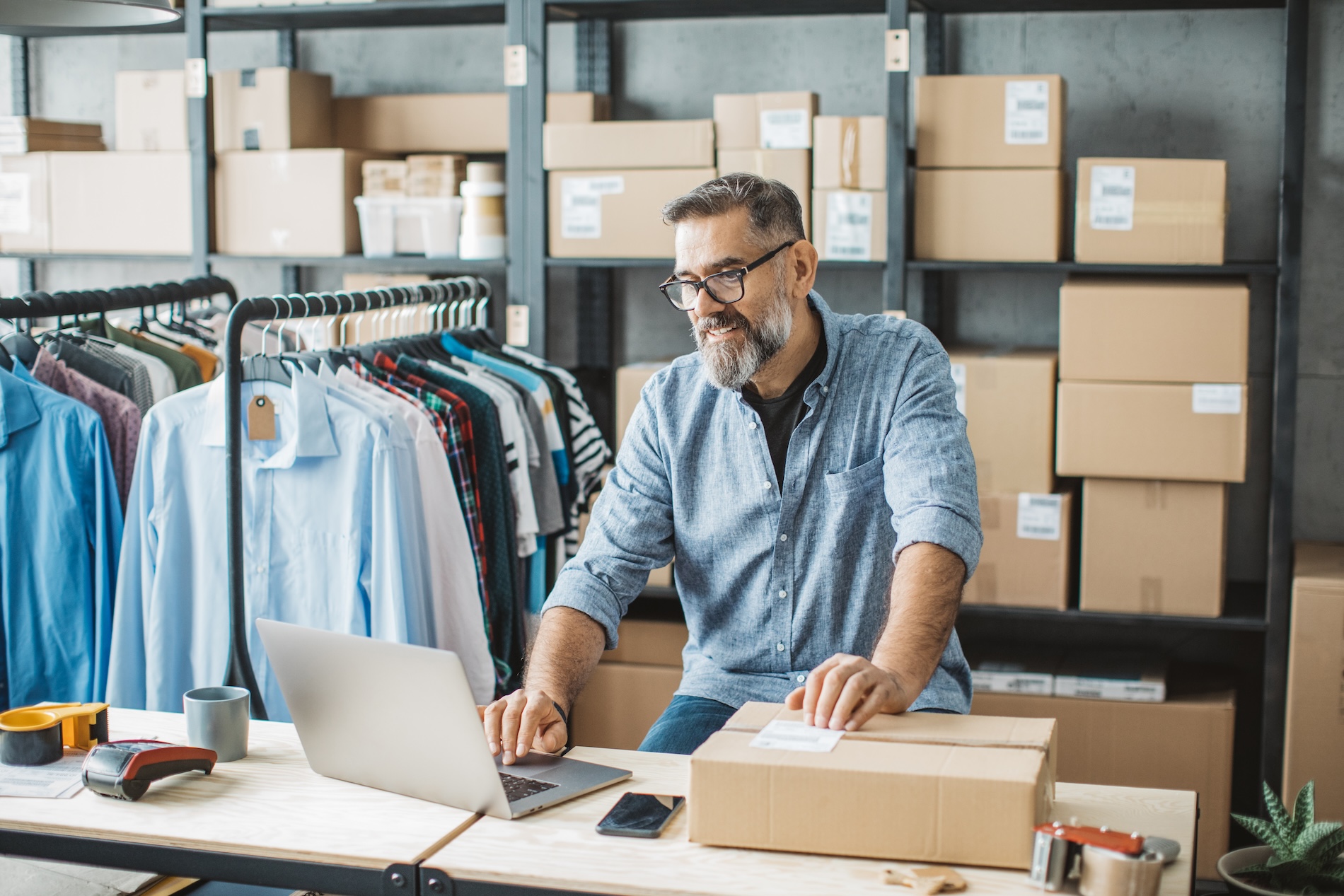 Small business owner managing e-commerce orders, preparing for a potential sale of the business.